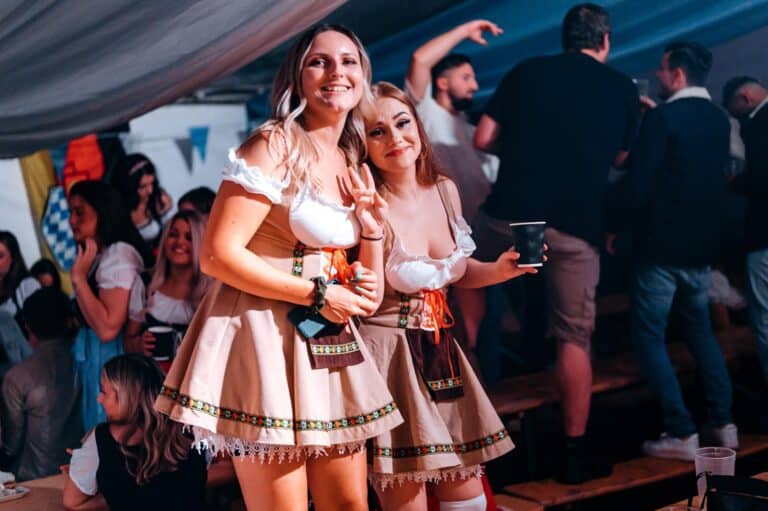 Two women in costumes at a party.